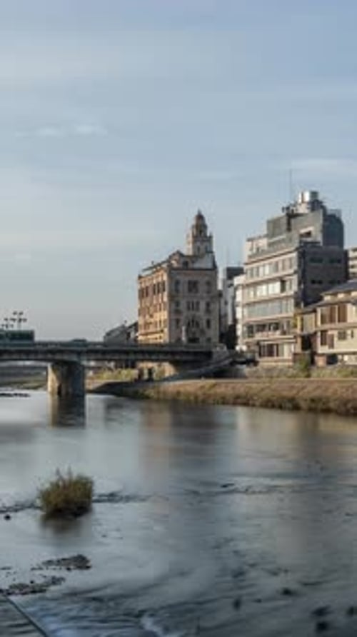 Cityscape skyline vertical time lapse video at Kamo river in a morning, Kyoto city, Japan.