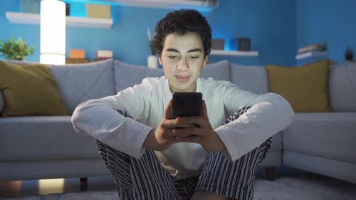 Teen Using Smartphone in Brightly Lit Living Room