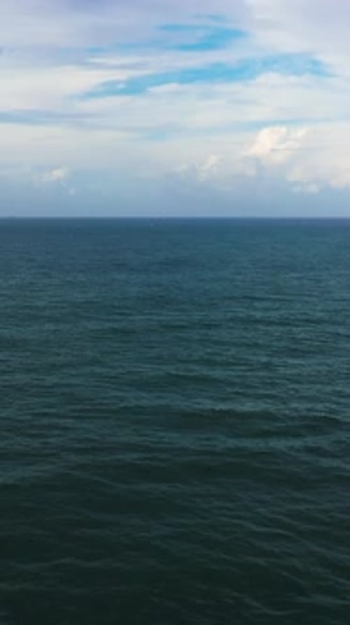 Beautiful White Clouds on Blue Sky Over Calm Sea