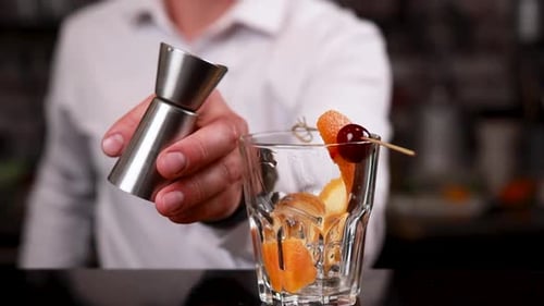 the bartender prepares a cocktail at the bar