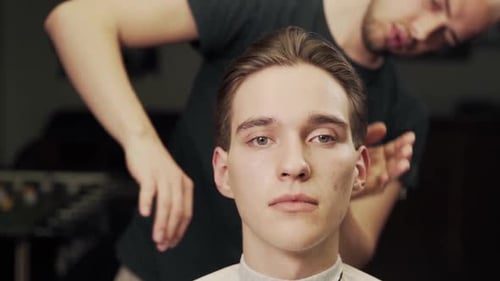 Young Man Getting Hair Styled at Barber Shop