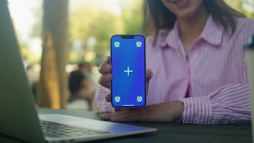 Woman Hand Holding Phone with Chroma Key Screen Outdoor Smartphone with Green Screen Closeup