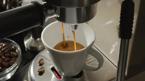 Espresso Pouring From Machine Into Mug