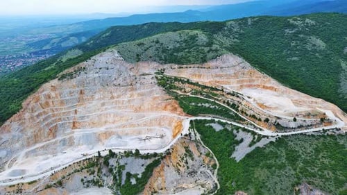 Natural Quarry is Located Near Road Against Backdrop of Rhodope Mountains and Hills with Forests and