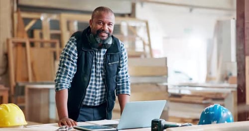 Black man, architect and smile at workplace with laptop for building ideas, plan and design online