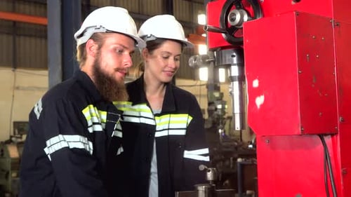Industrial engineer working with automated arm robot inside AI robotic production factory.Technology