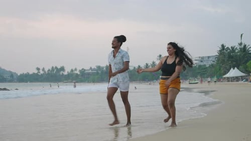 Joyful Diverse Friends Play Run By Sea at Sunset LGBTQ Group Enjoys Beach Splashes in Water