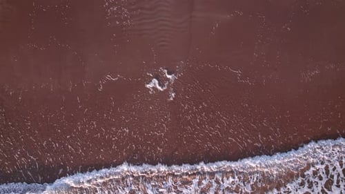 Abstract Top Down Foamy Ocean Waves Breaks Beach