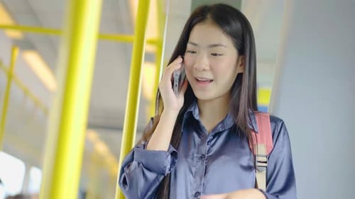 Woman Talking on Phone Riding Public Transportation