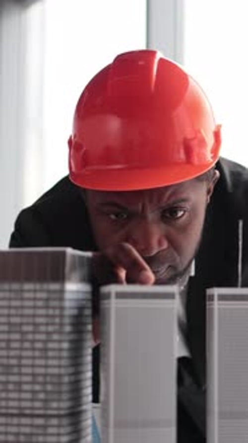 Architect Inspecting Building Models