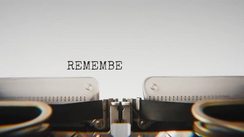 Old mechanical typewriter typing Remember Our Laughs in a close-up view.