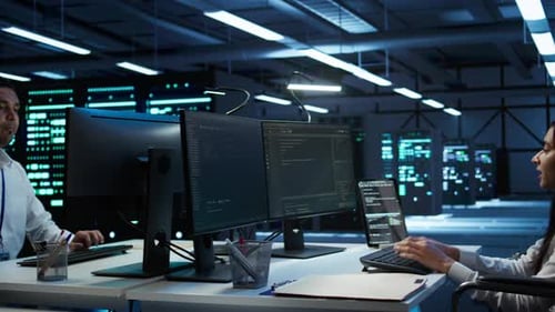 System Administrator Overseeing Data Center Using Green Screen Computer