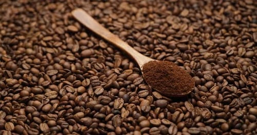 Wooden Spoon Full on a Roasted Coffee Beans Spinningbackground Top View High Quality Footage