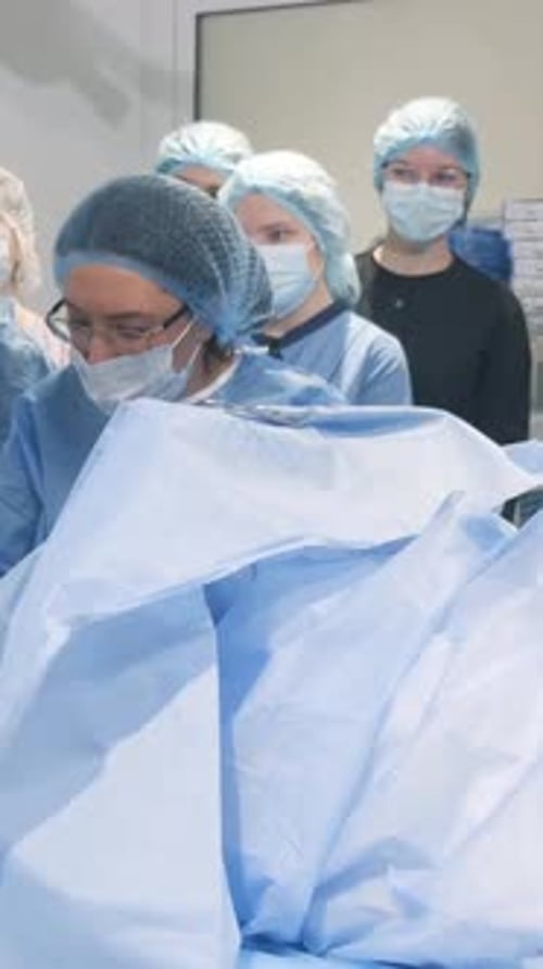 A Doctor and Assistants Perform Surgery on an Old Woman Students on Surgical Operation Vertical