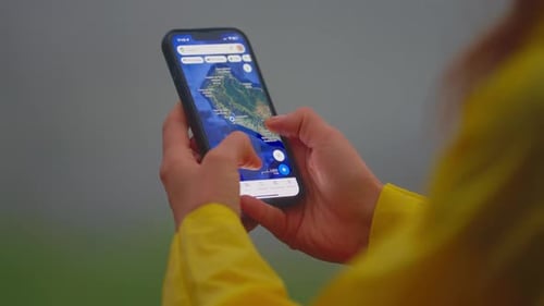 Woman Using Map Application on Smartphone Outdoors