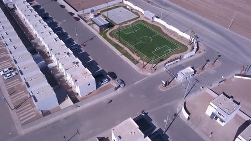 View of a drone flying over a residential to the soccer field and basketball court