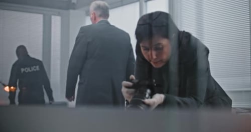 Office Robbery or Murder Case Female Criminalist Takes Photos of Evidence at Crime Scene