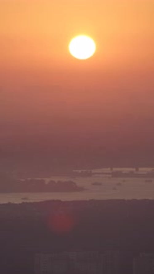 Sunset Over City Skyline with River View in Warm Colors