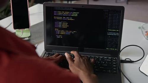 Black Female Software Developer Typing Code on Laptop Computer