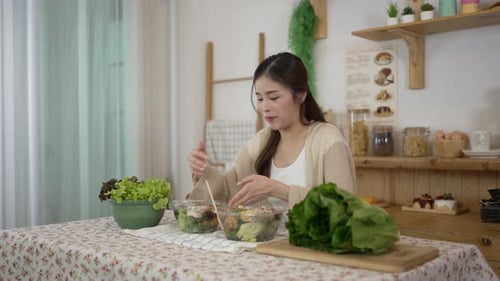 Woman Preparing Salad in Bright Kitchen