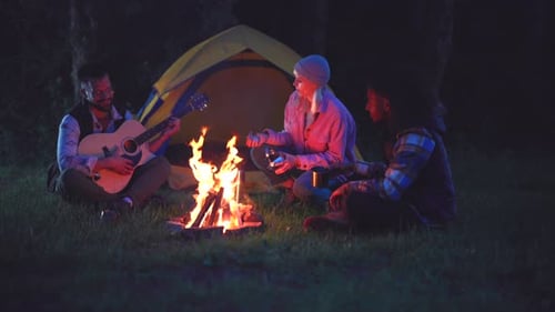 Friends Camping, Man Playing Guitar at Night