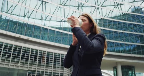 Smiling Business Woman Talking on Phone With Coffee