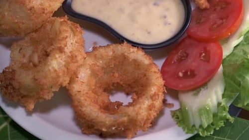 Fried onion rings Appetizer with Close Up Spinning on a Plate