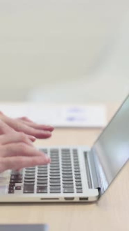 Side View of Male Hands Typing on Laptop, vertical video