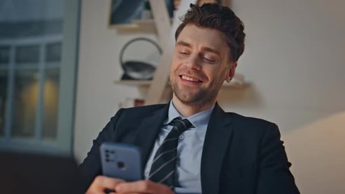 Joyful Office Worker Messaging Cellphone Sitting Office at Evening Closeup