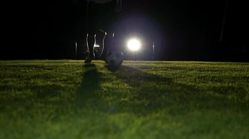 Soccer Player Athlete Training Foot Ball Sport on Soccer Field at Night