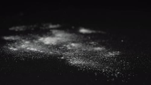 White Powder Sprinkled on Dark, Black Background