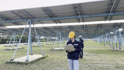 Engineers working at Solar station in Solar Farm. Solar energy farm on the field. Solar panels