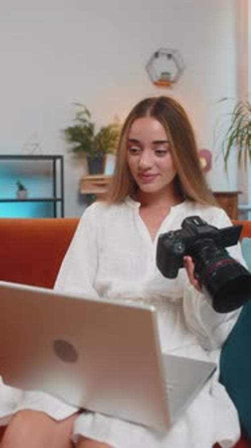 Woman Reviews Camera on Laptop at Home