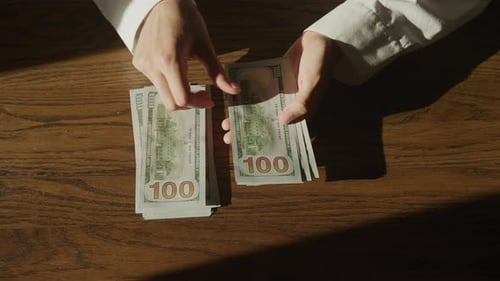 Top View Hands Counting Cash Money Dollar Bills in Slow Motion
