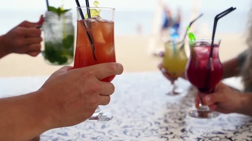 Group of Friends Cheering Cocktails at Beach Bar People Clinking Glasses at Cafe Outdoors Couple