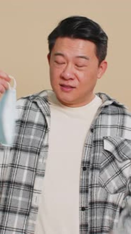 Man Removing Face Mask, Smiling