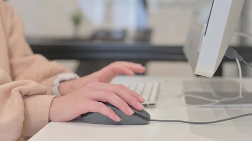 Close up of Woman Using Computer Mouse