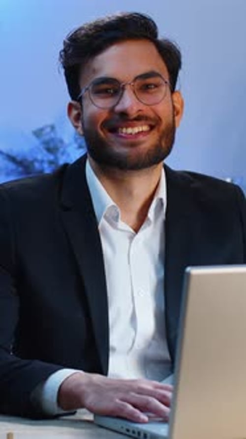 Portrait of Happy Smiling Bearded Indian Business Man at Home Office Look Away Turn Head at Camera