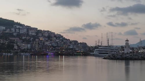 View of Alanya and harbour with ships at evening. Time-lapse.