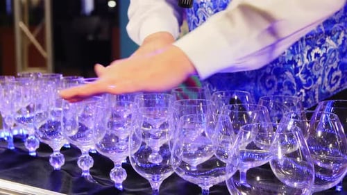 Barman Plays Music on Singing Wineglasses at Bar Counter
