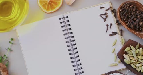 Food, spices and recipe in book on kitchen counter for cooking or dinner plan for meal prep in home