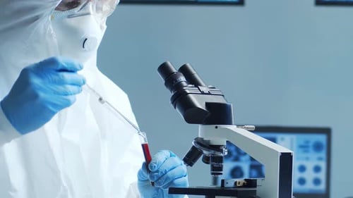 Scientist Analyzing Sample with Microscope in Lab