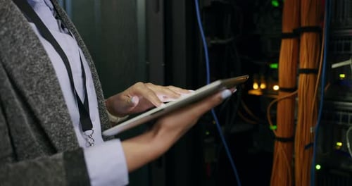 Woman Using Tablet in a Server Room