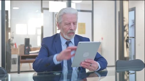 Senior Adult Upset with Tablet in Meeting Room