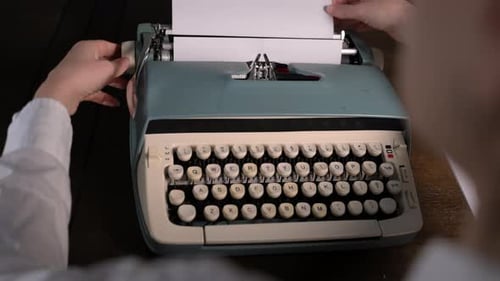 Typing story on vintage typewriter on wooden desk