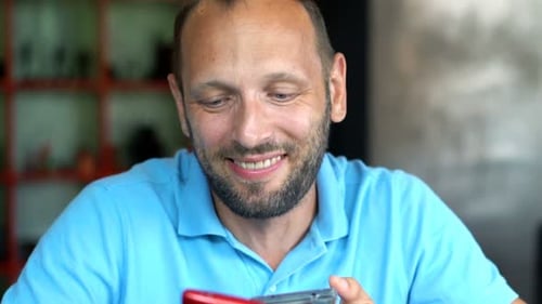 Man Sharing Something Amusing on His Mobile Phone