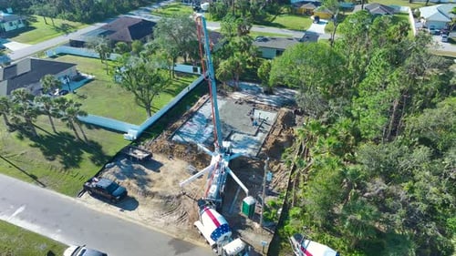 Construction Workers at New House Building Site Pouring Concrete of Flat Slab Foundation Bedding