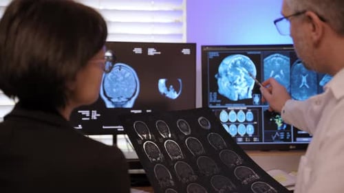 Doctors Analyze Brain Scans in Hospital Office