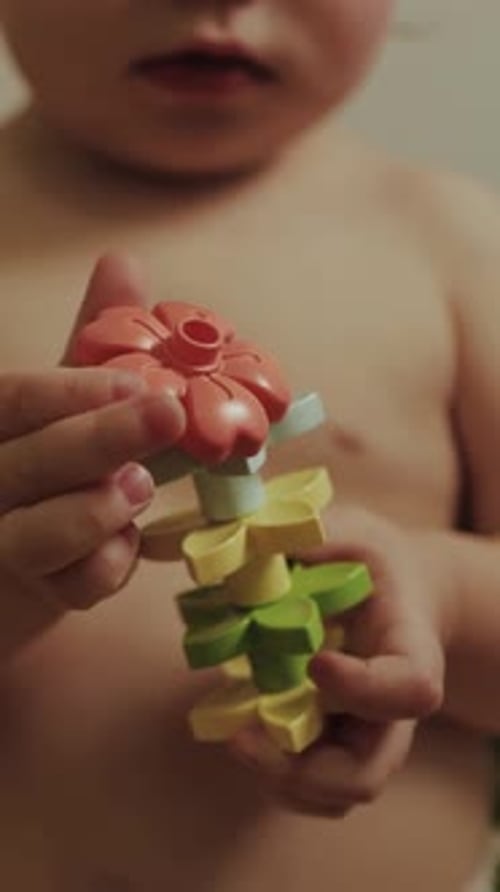 Toddler Playing with Flower Stacking Toy Indoors