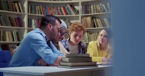 Mixedraces Young Males and Females Friends Sitting at Table in Library Talking Cheerfully and